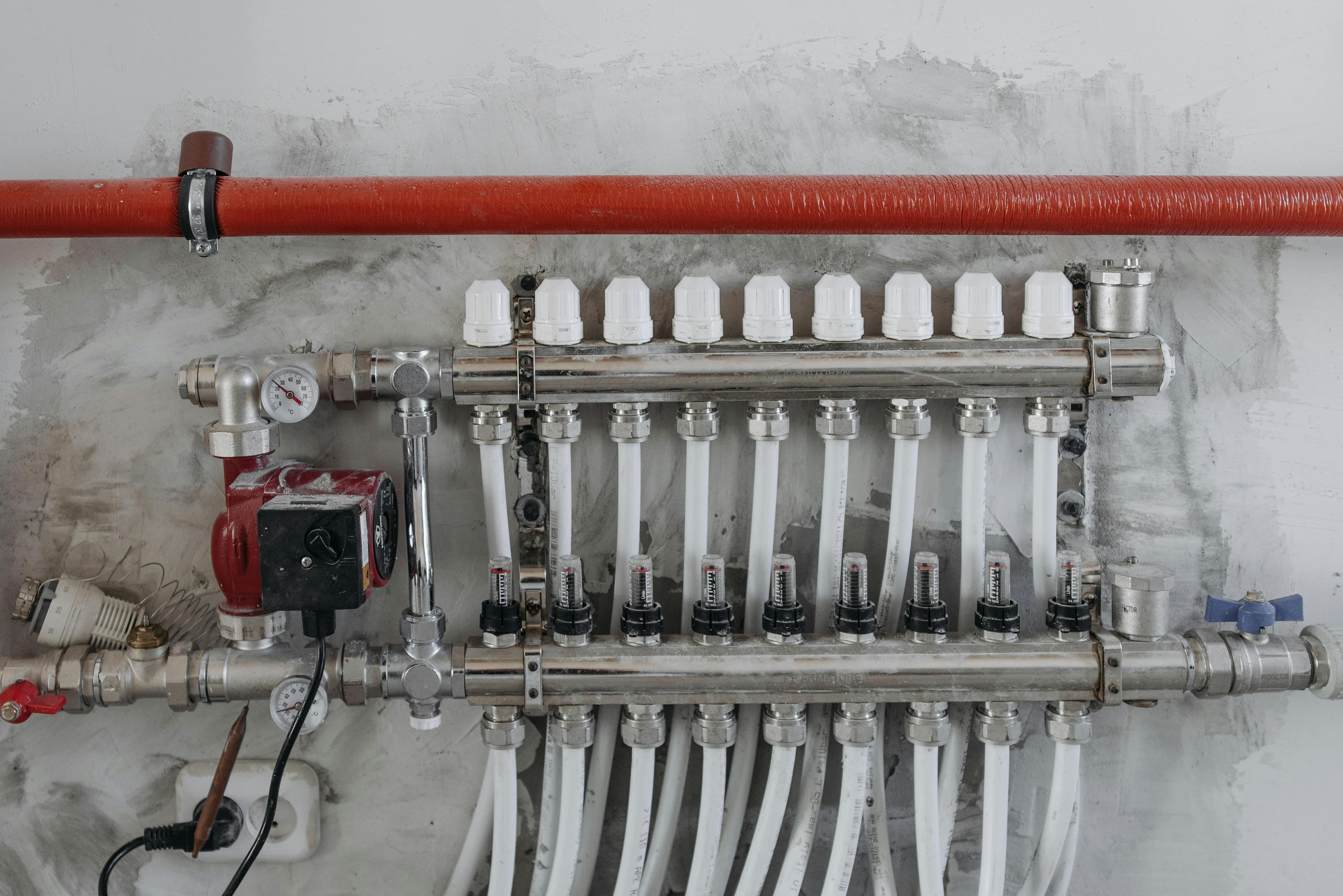 Steel underground heating manifolds and plumbing systems